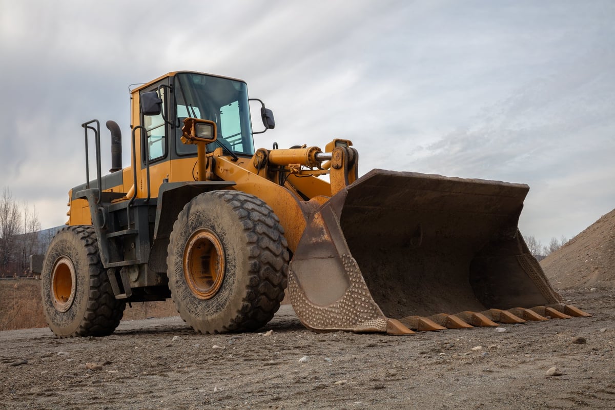 Backhoe with a large bucket on a cleared site